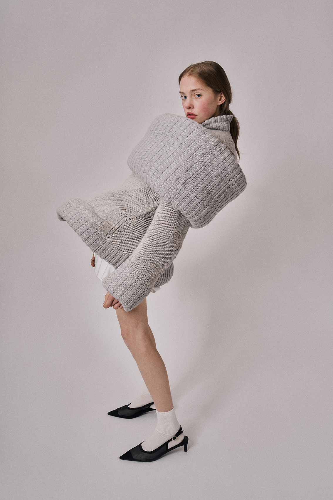 art direction and creative direction - Studio Gerritsen-Bart woman wearing wool grey shaped sweater with clips in het hair